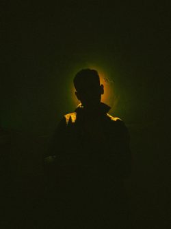 A silhouette of a person in yellow light.